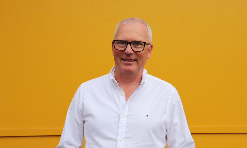 Image of Peter Leonard in front of a yellow wall