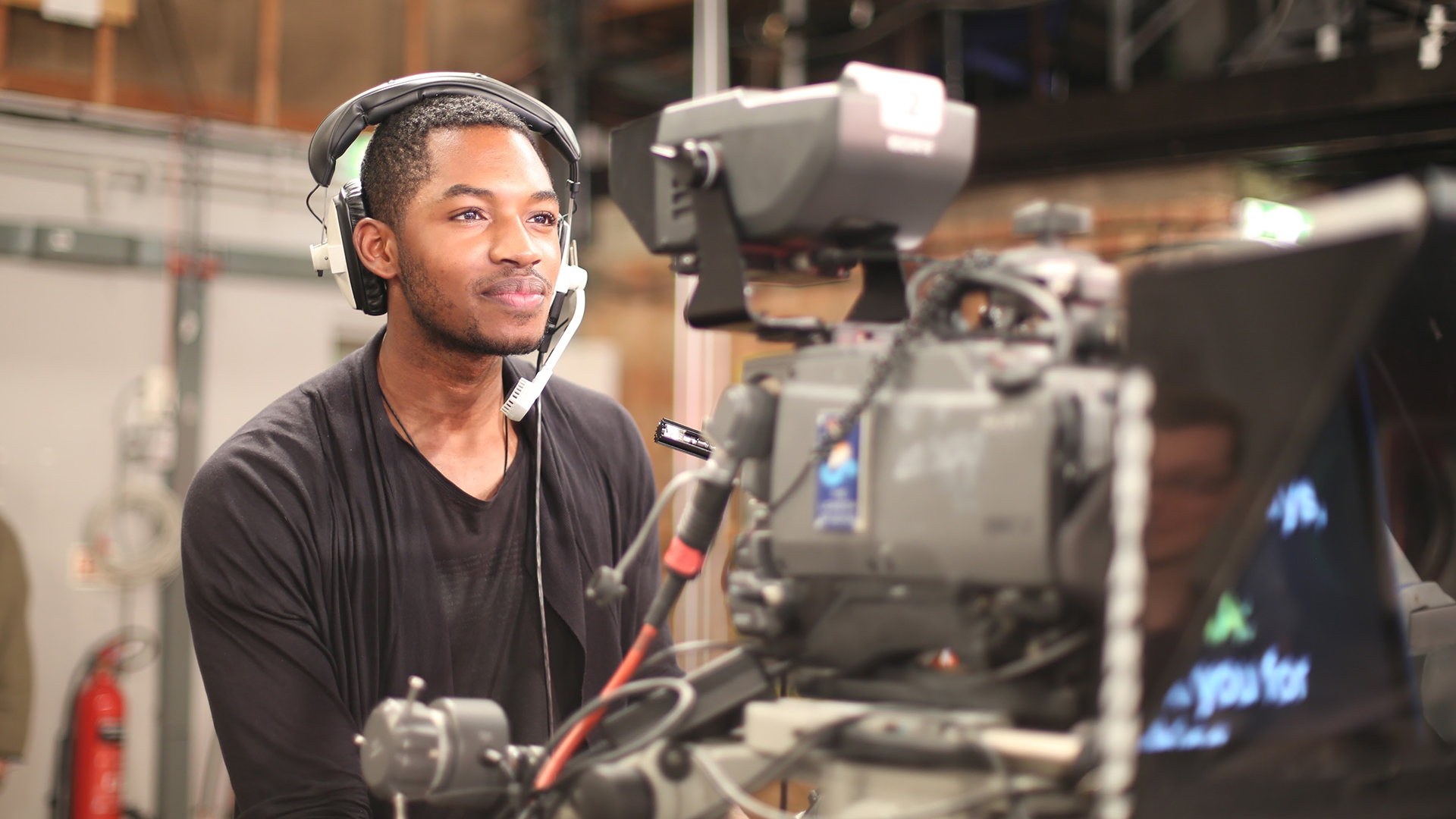 Student working behind camera on television show