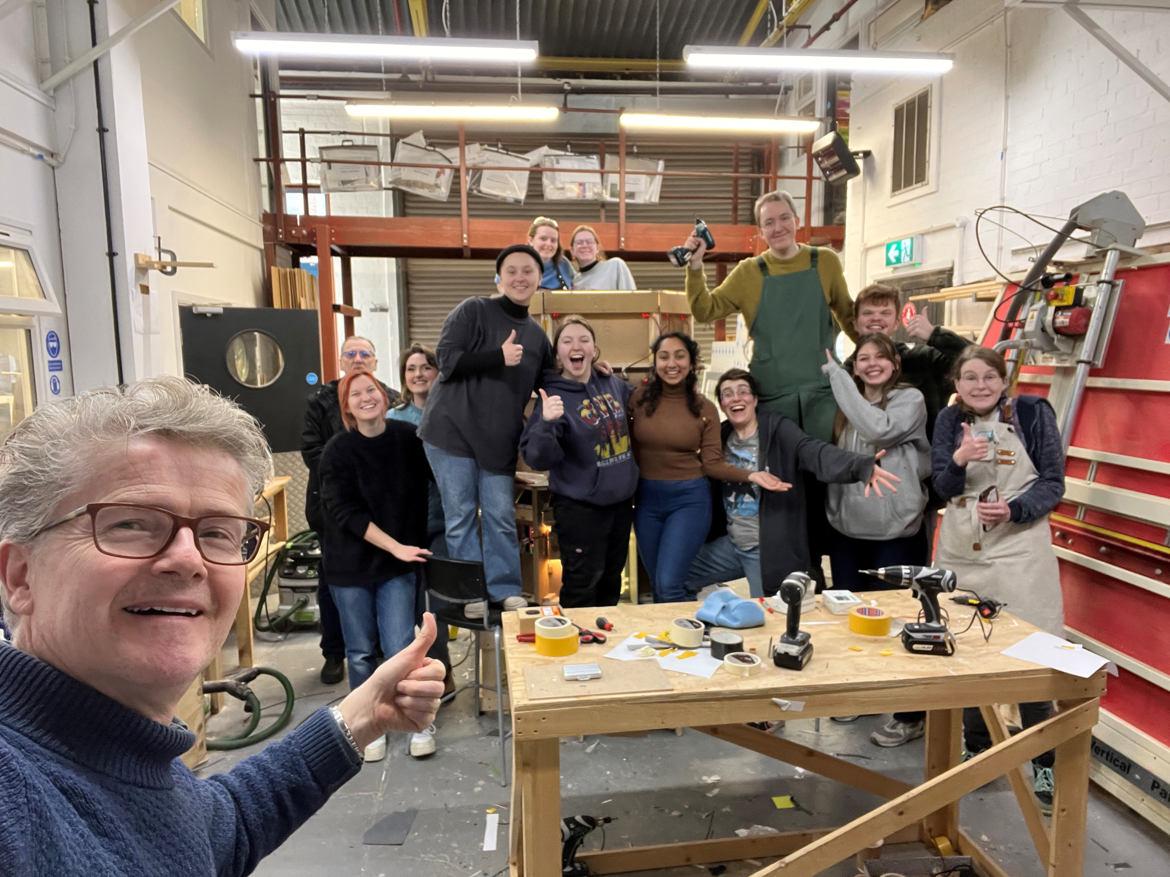 group of people taking selfie in workshop