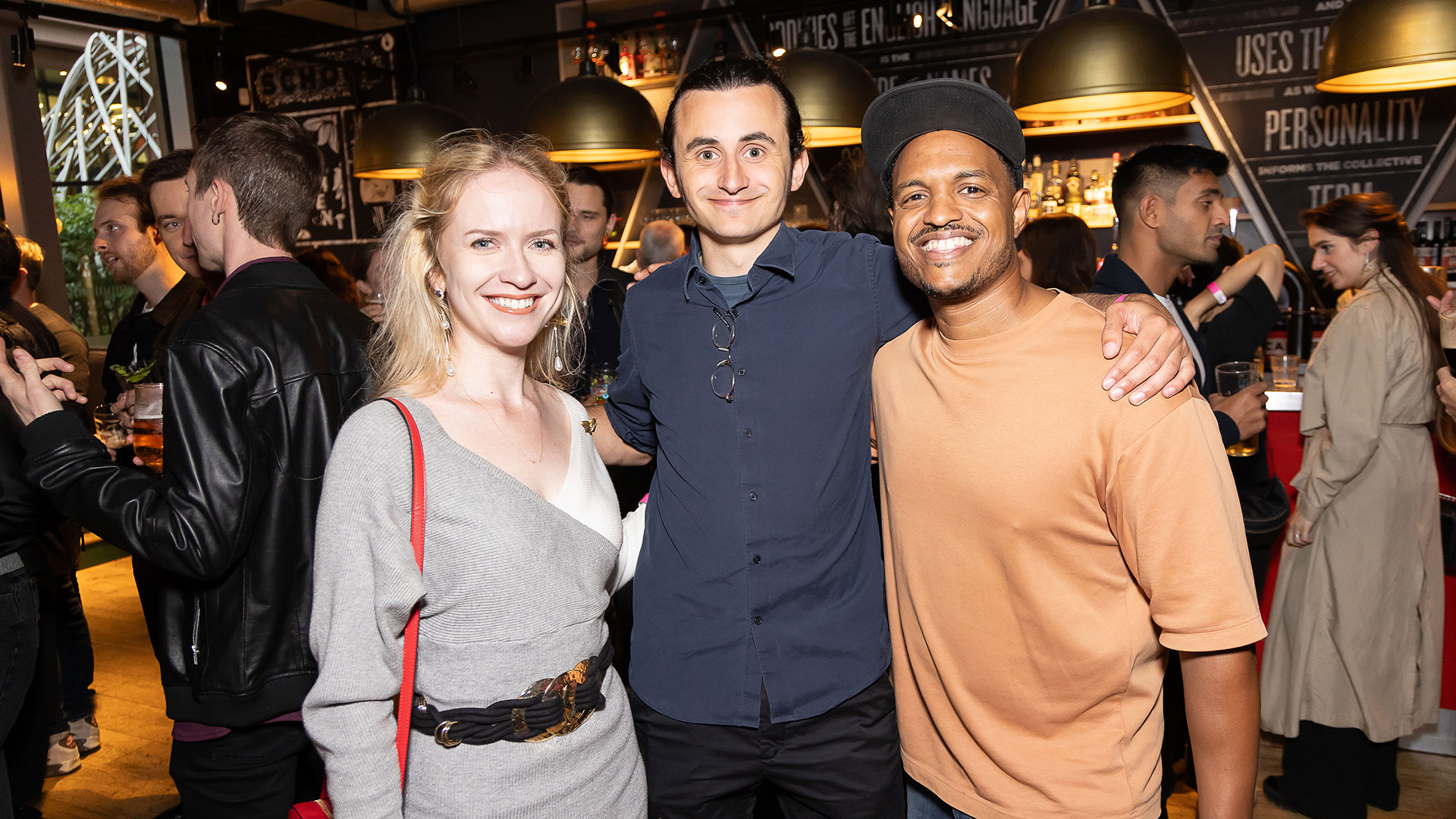 Alumni at party posing for photograph