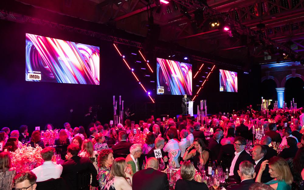 Gala event with people sat at tables, facing the stage