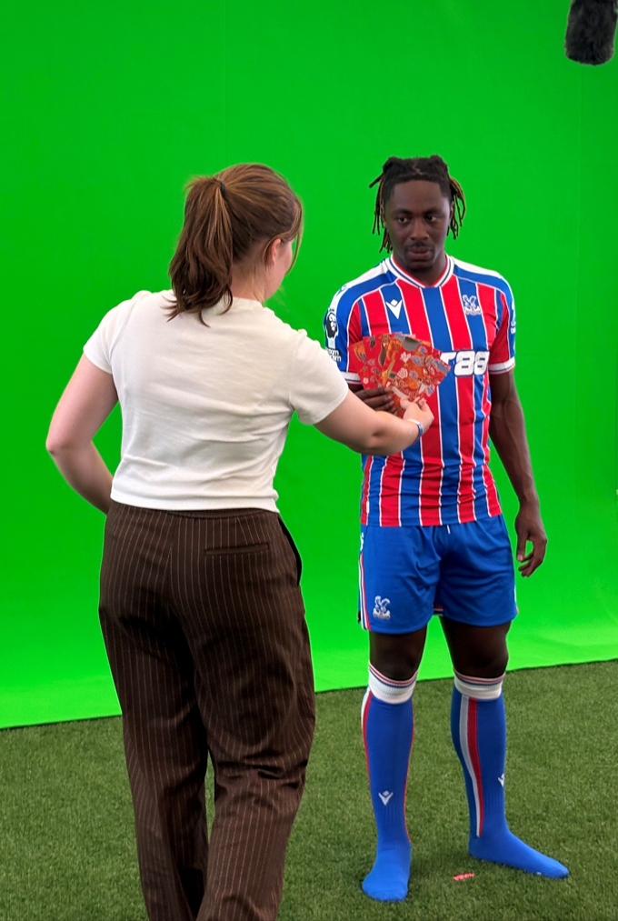 Harriet with footballer in front of green screen on shoot