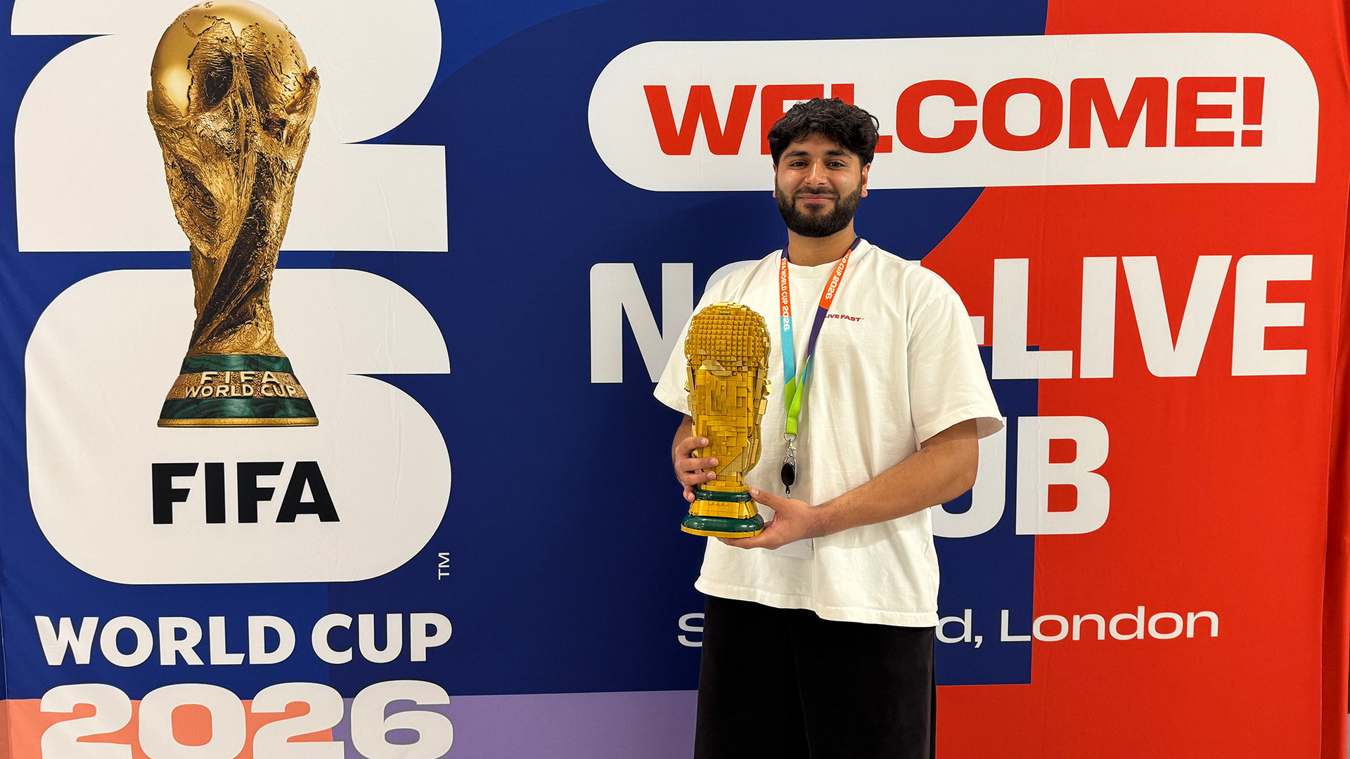 Ibrahim stood by FIFA World Cup backdrop with lego trophy