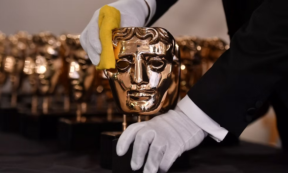 person polishing bafta awards