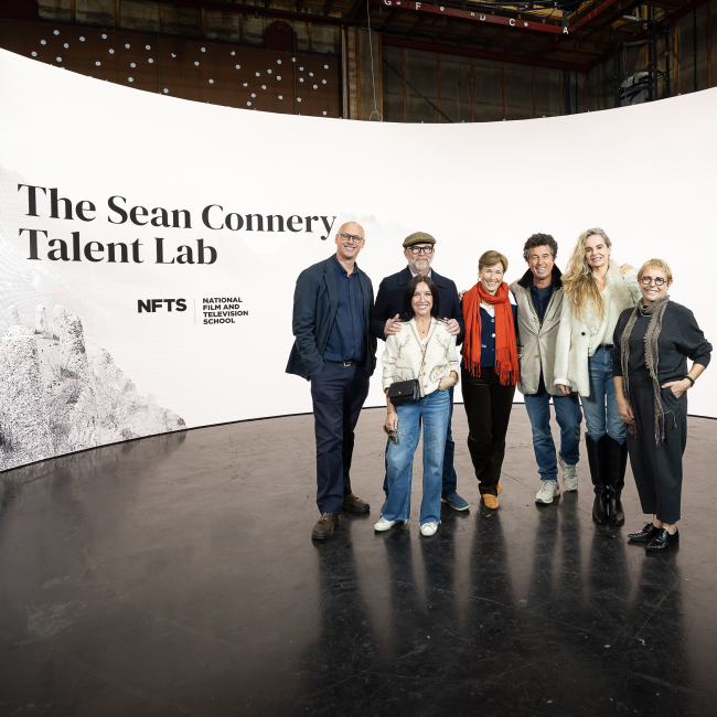 group of people stood in front of led wall with sean connery talent lab and image of sean connery