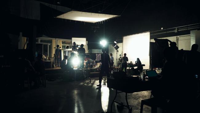 film set with people working