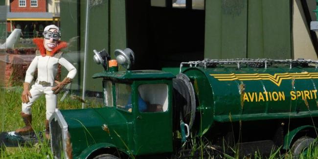puppet next to model train