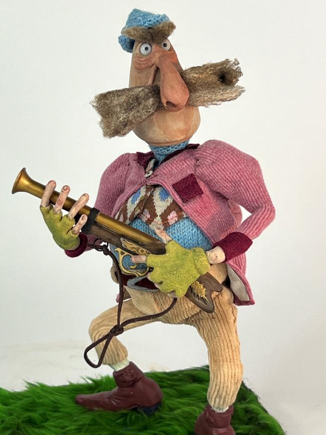 model of a hunter holding an old rifle