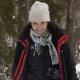 Lloret walks to camera in the snow wearing woolly hat