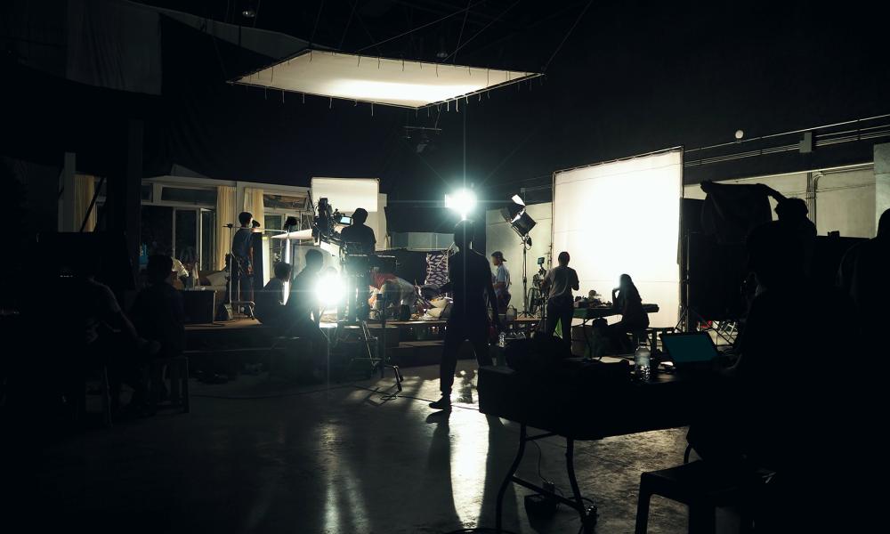 film set with people working