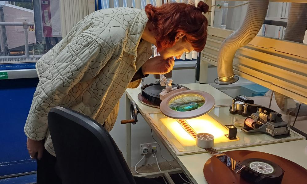 NFTS Student looking at a Film Reel