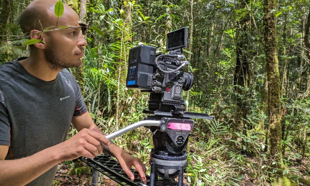 Nathan Small in rainforest with camera