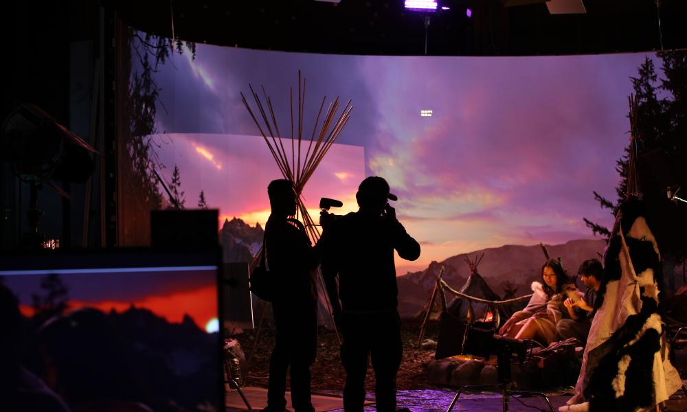 virtual production stage with actors and crew