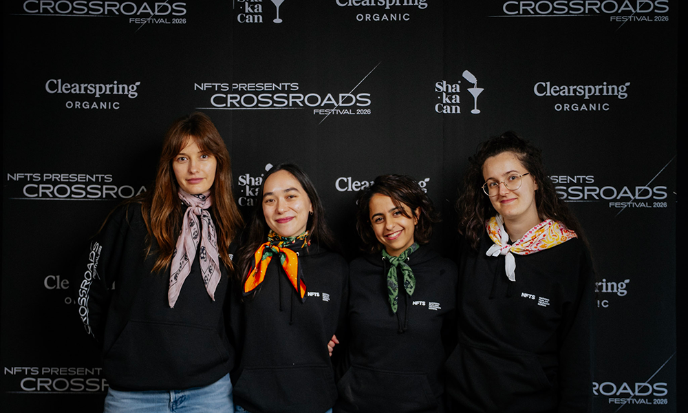 people stood in front of logo wall