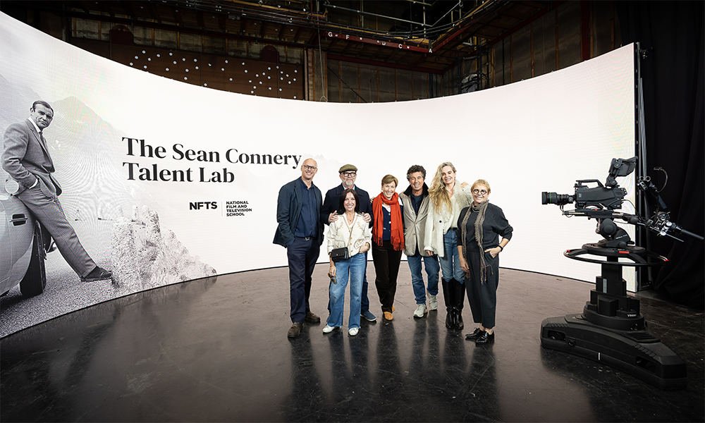 group of people stood in front of led wall with sean connery talent lab and image of sean connery
