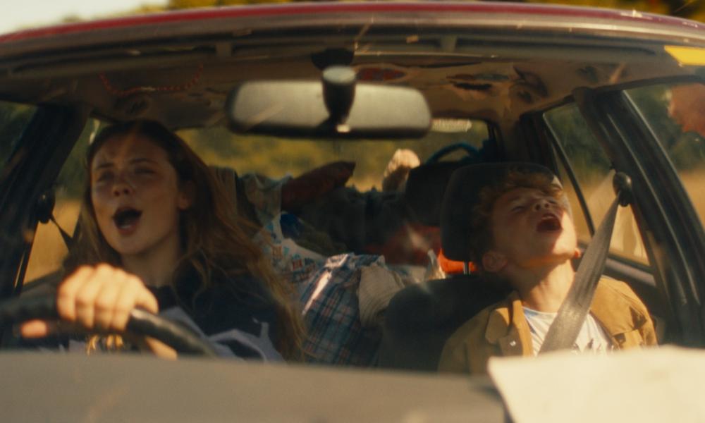 still from bandits showing woman and boy laughing in car