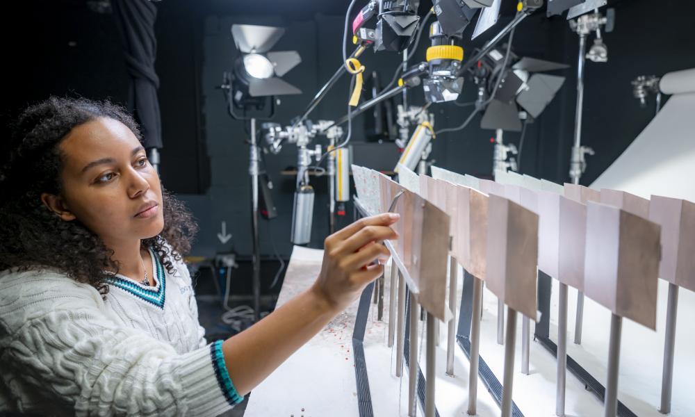 Animation student adding detail to their set in the studio