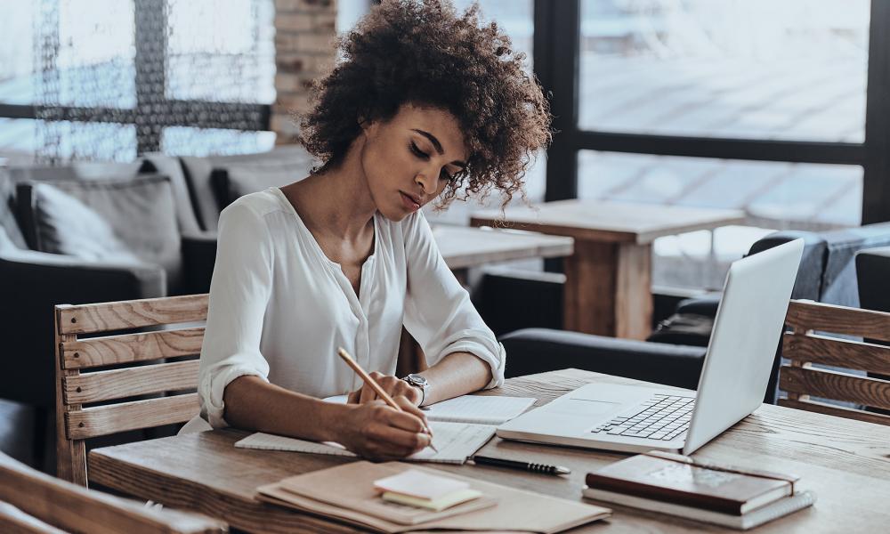 Woman at a desk writing